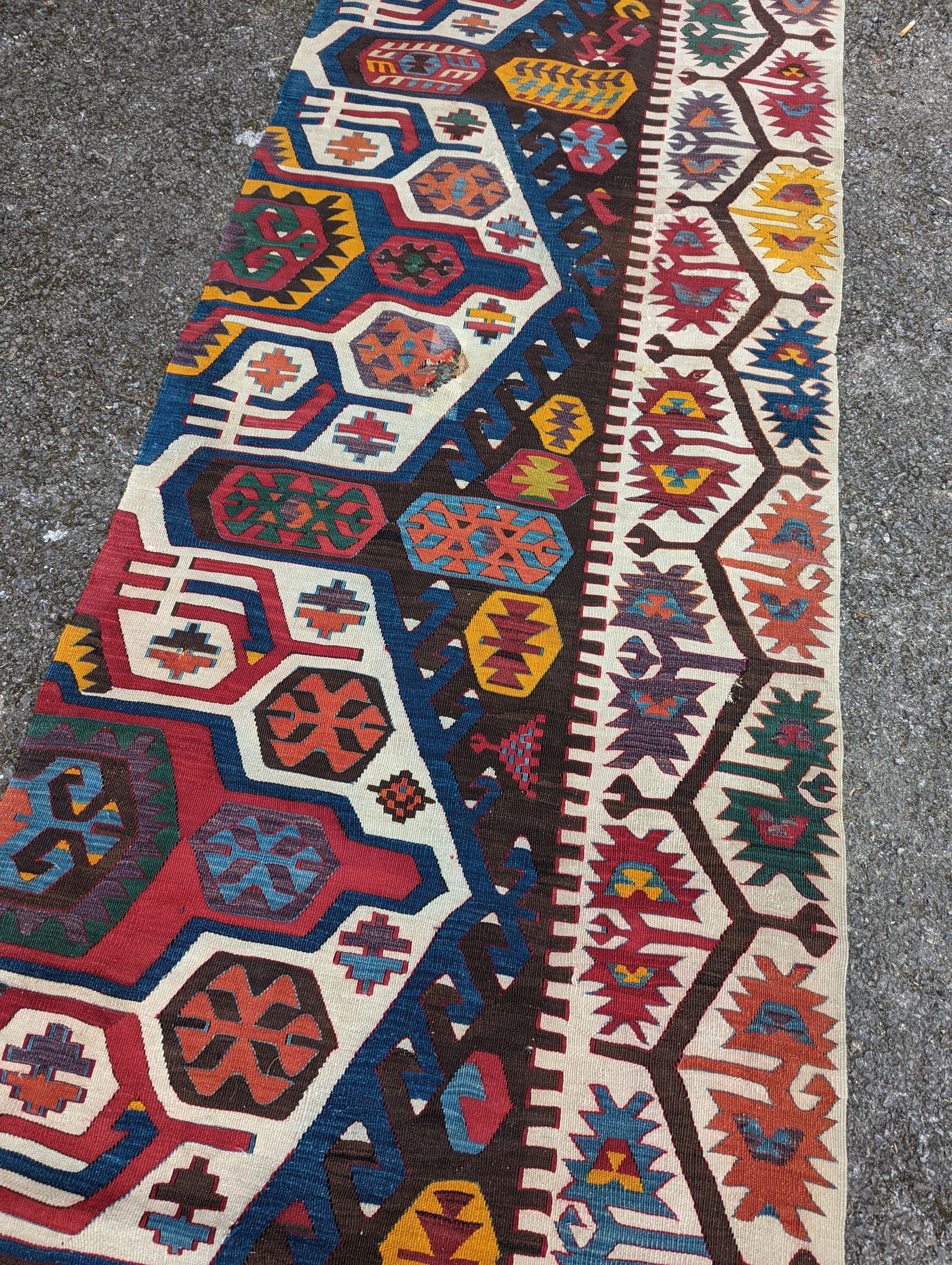 A large Kilim flatweave runner, 400 x 92cm (holed and cut)